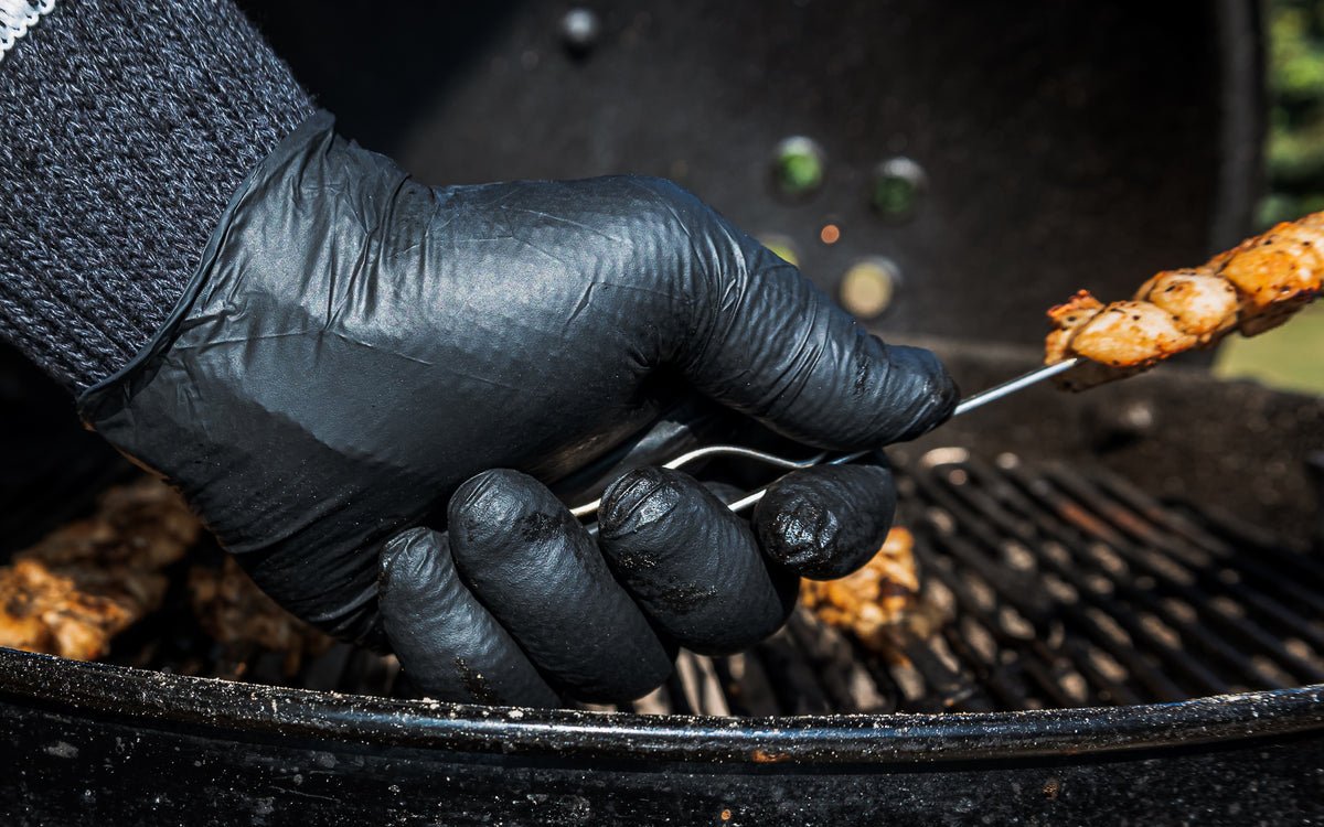 Charbasil Grilling Gloves holding chicken