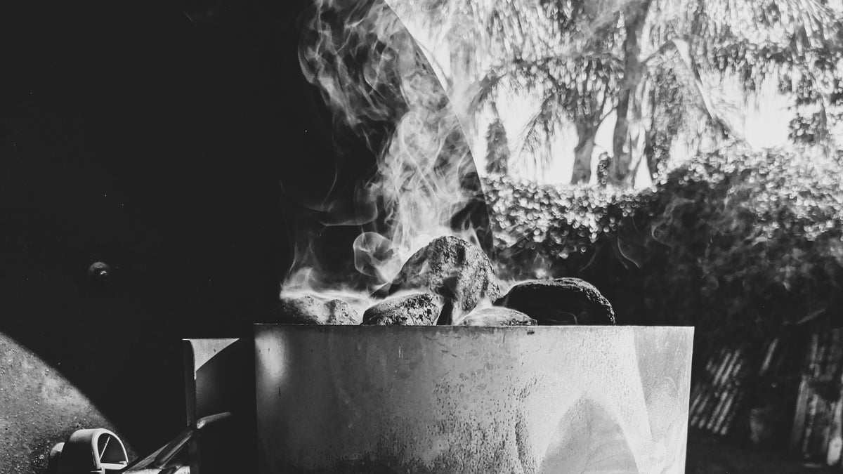 Smoke rising from a charcoal chimney